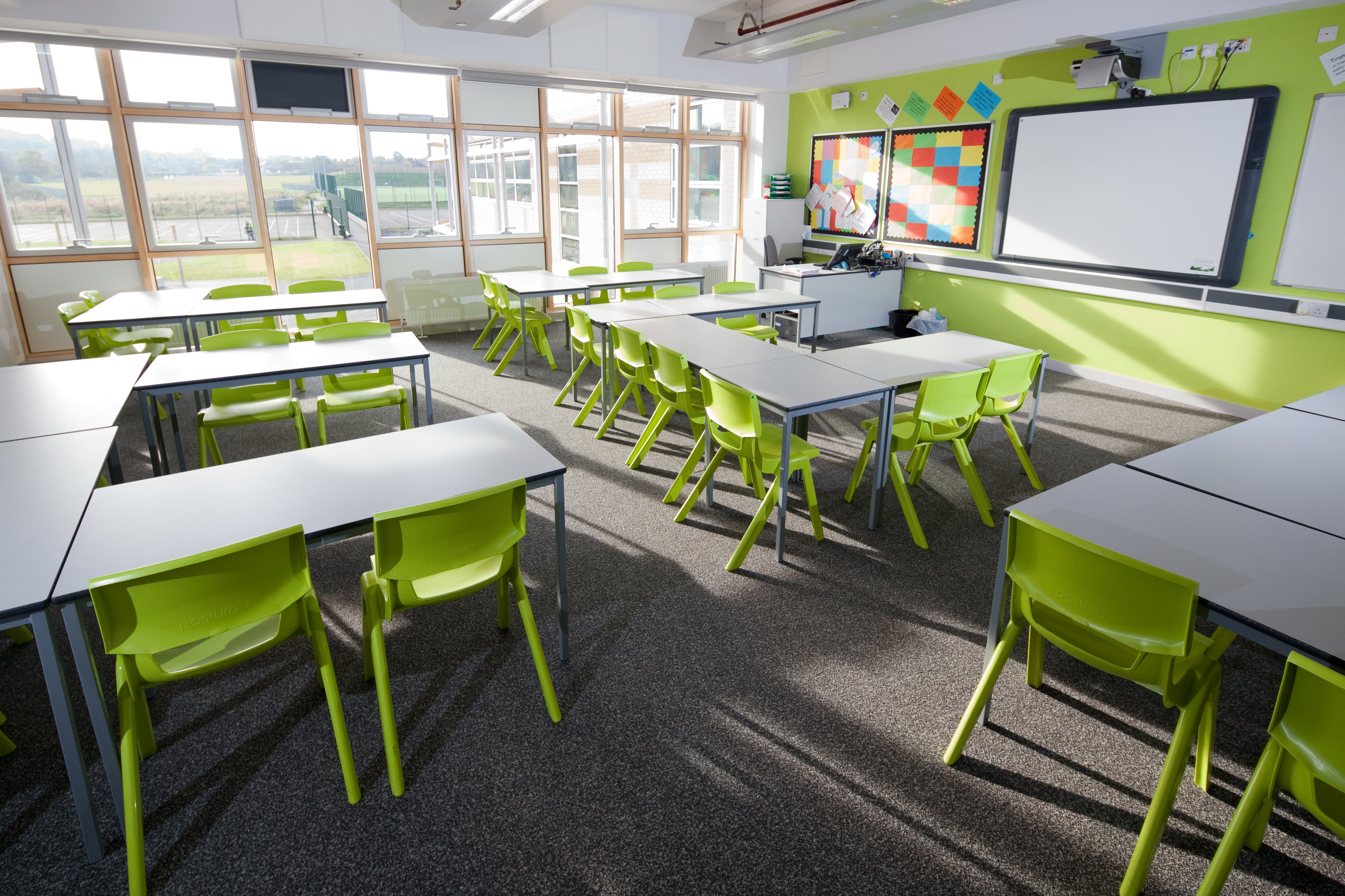 green one piece chairs in a pleckgate high school classroom